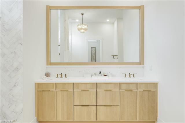Full bath with double vanity and a sink