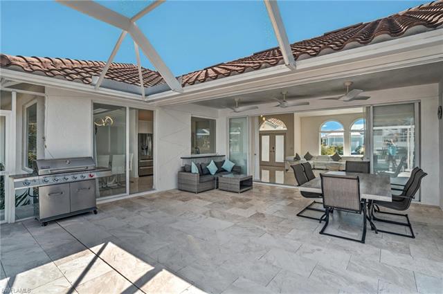 View of patio / terrace featuring glass enclosure, french doors, a ceiling fan, a grill, and an outdoor hangout area