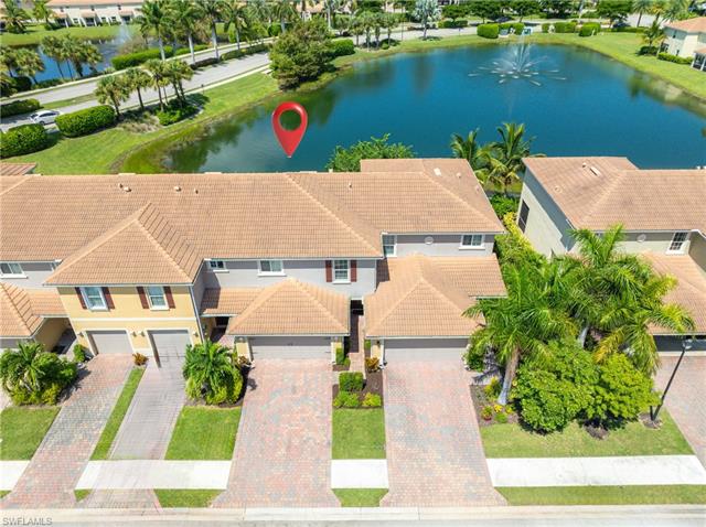 Birds eye view of property with a water view