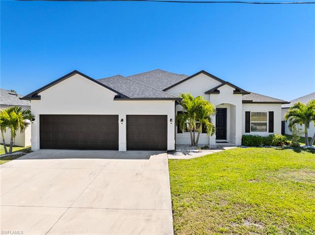 View of front of property with stucco siding, driveway, a front lawn, an attached garage, and a shingled roof