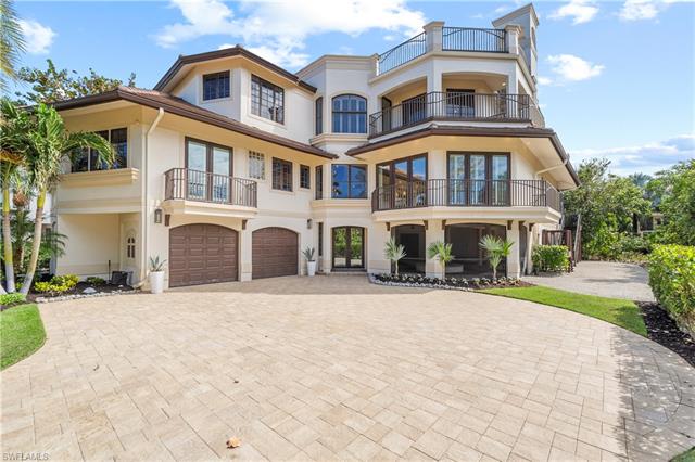 View of front of home featuring central air condition unit, stucco siding, french doors, decorative driveway, and an attached garage