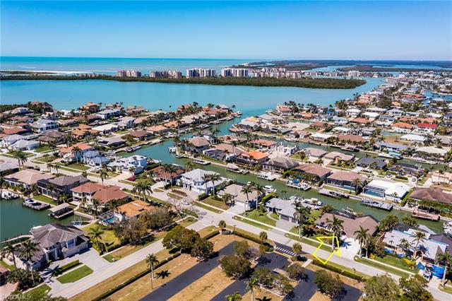 Birds eye view of property with a water view and a residential view