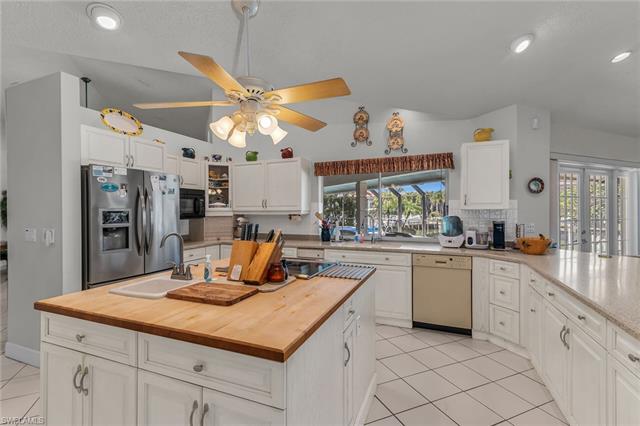 Gourmet Kitchen Featuring a Butcher Block Island Counter with New Electric Range