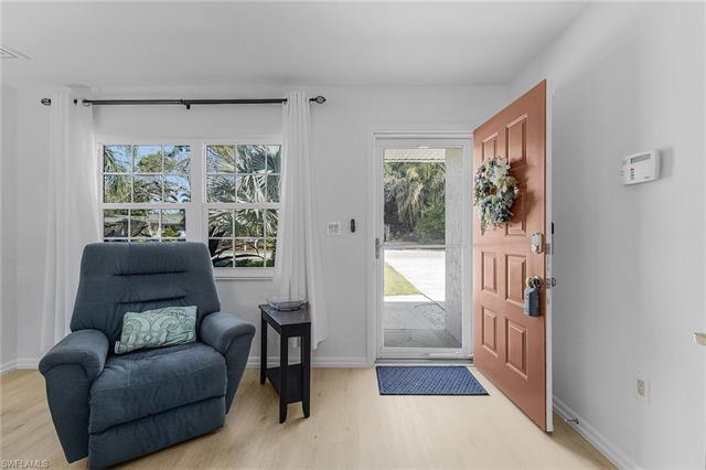 Foyer entrance with baseboards and light wood-type flooring