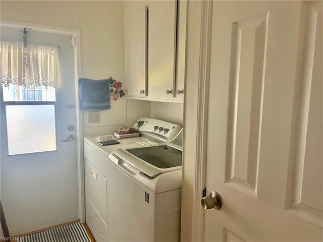 Laundry room with cabinet space and washing machine and clothes dryer