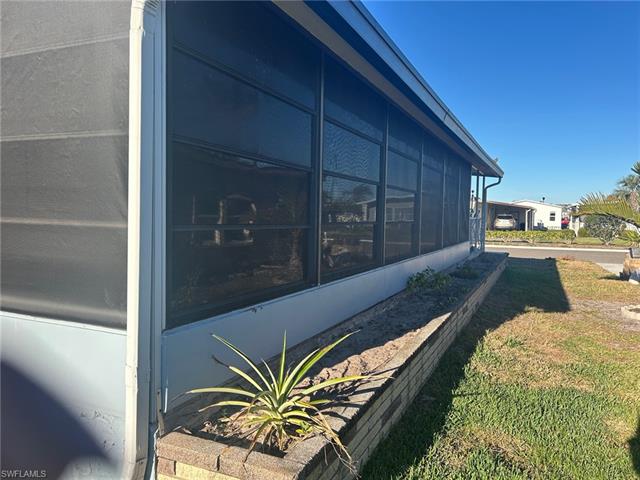 View of side of property featuring a sunroom
