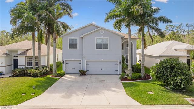 View of front of home featuring stucco siding, an attached garage, concrete driveway, and a front yard