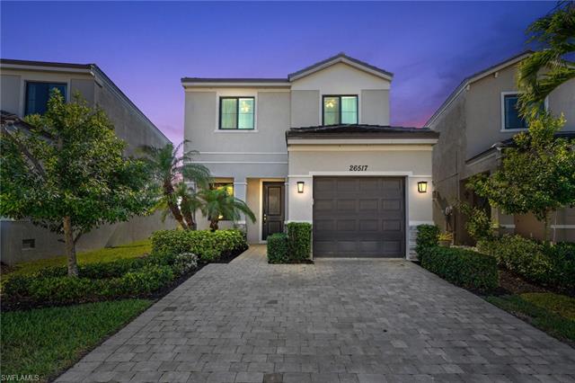 View of front of house with stucco siding, an attached garage, and decorative driveway