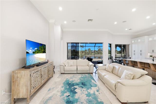 Living room featuring light tile patterned flooring, recessed lighting, and crown molding