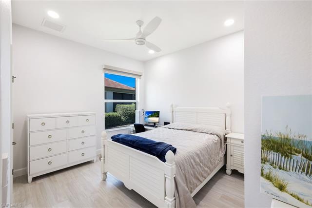 Guest Bedroom with light plank tile floors, recessed lighting, and a ceiling fan