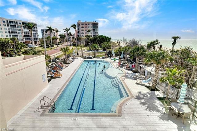 Pool with a patio area and fence