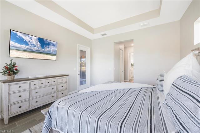 Bedroom featuring a raised ceiling and hardwood / wood-style floors
