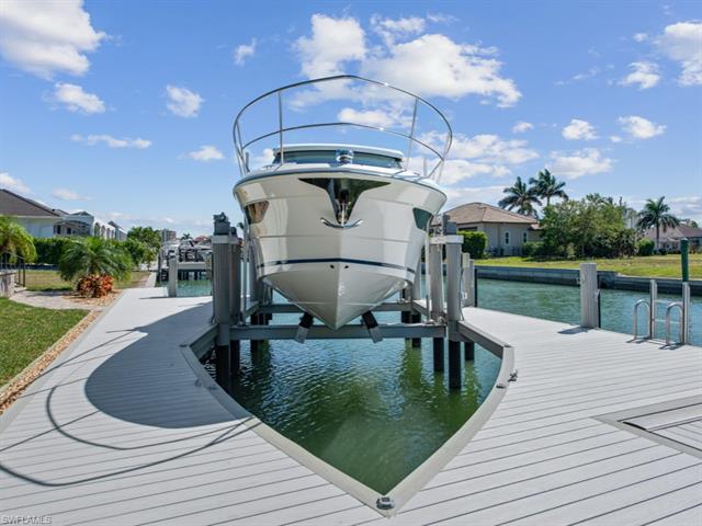 Dock area with a water view and boat lift
