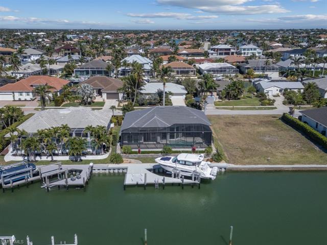Birds eye view of property featuring a residential view and a water view