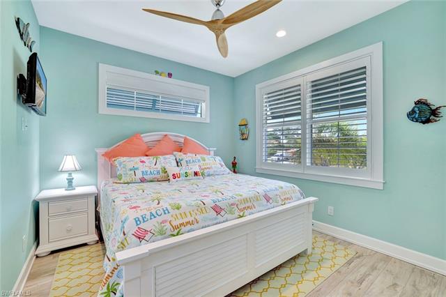Bedroom with light wood-style flooring, baseboards, and ceiling fan