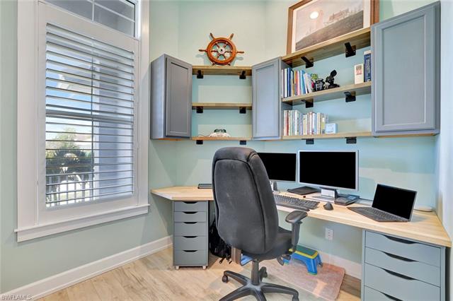 Office area with baseboards and light wood-style floors