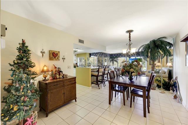 Dining area featuring an inviting chandelier, light tile patterned floors, and visible vents