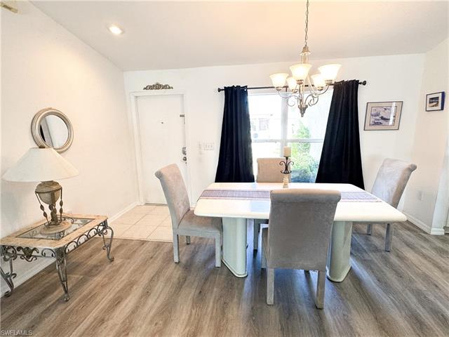 Dining space featuring baseboards, a notable chandelier, and wood finished floors