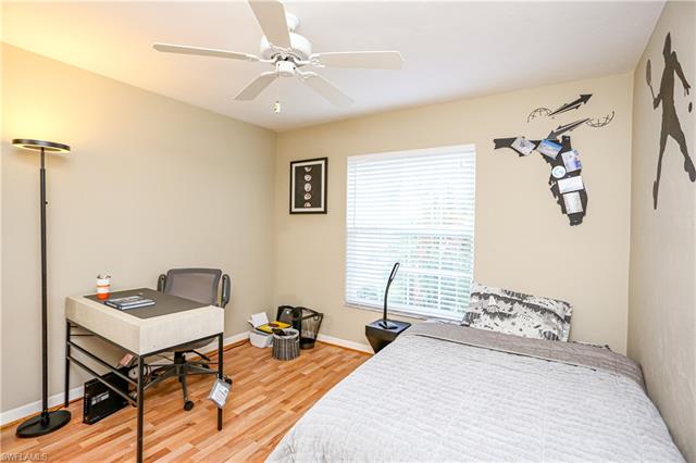 Bedroom with baseboards, ceiling fan, and wood finished floors