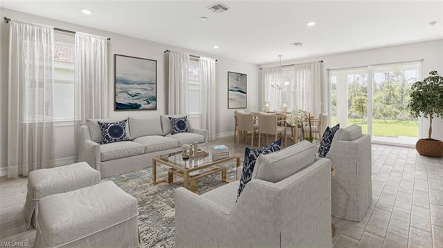 Living room with baseboards, visible vents, a notable chandelier, and recessed lighting