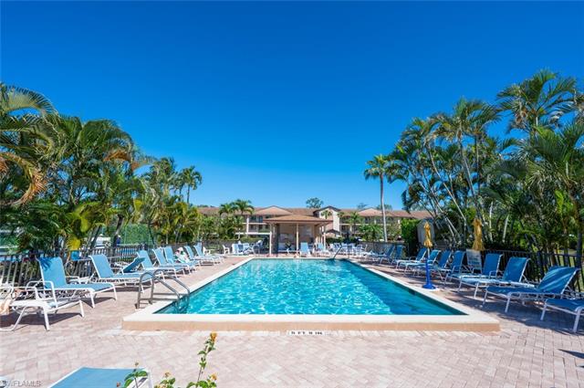 Community pool with fence and a patio