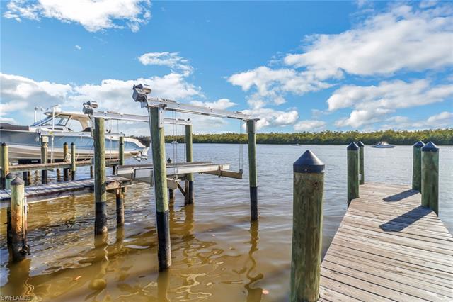 View of dock with a water view and boat lift