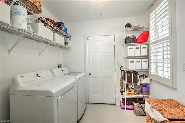 Laundry area with separate washer and dryer, plenty of natural light, and laundry area