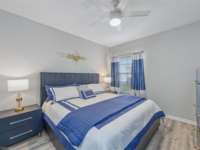 Bedroom with baseboards, ceiling fan, and wood finished floors