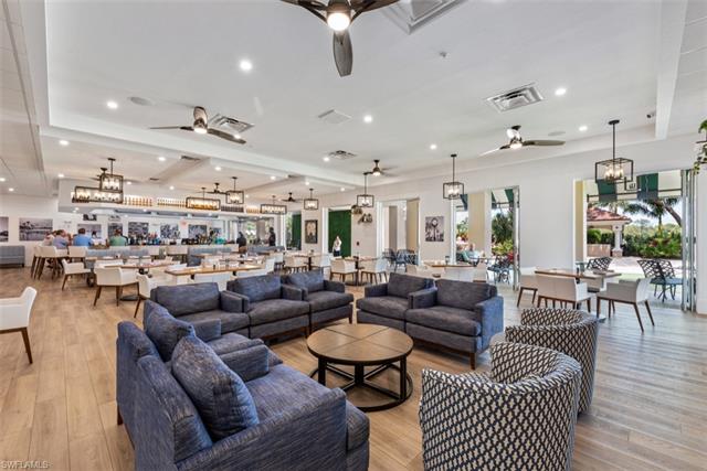 Living room featuring ceiling fan with notable chandelier, light wood finished floors, and visible vents