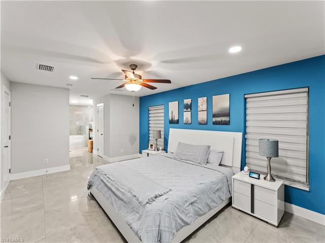 Bedroom featuring baseboards, marble finish floor, and visible vents