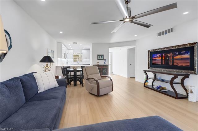 Living area with light wood-type flooring, a ceiling fan, recessed lighting, and visible vents