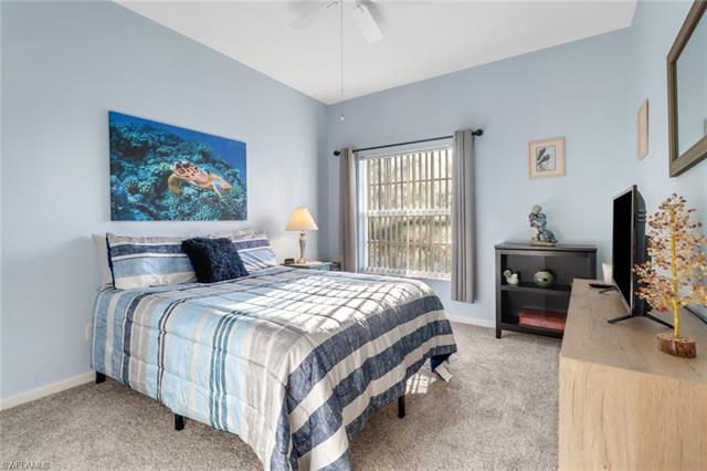 Bedroom featuring ceiling fan and carpet