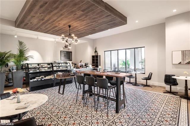 Dining area with rail lighting, recessed lighting, baseboards, a chandelier, and wood ceiling