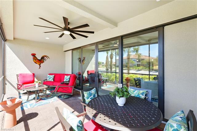 Sunroom featuring a ceiling fan, beamed ceiling, and outdoor dining space