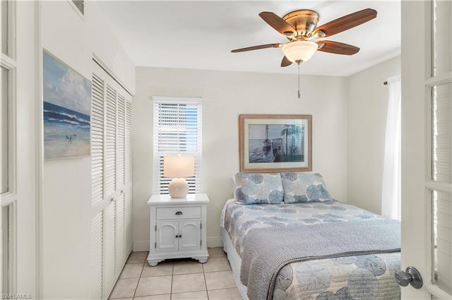 Bedroom with visible vents, ceiling fan, and light tile patterned floors