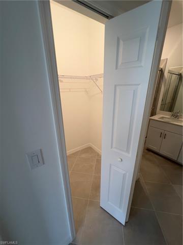 Spacious closet featuring a sink and tile patterned flooring