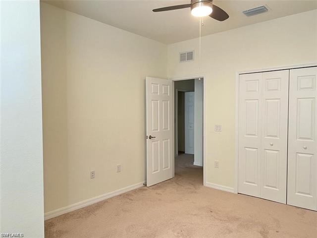 Unfurnished bedroom featuring light colored carpet, visible vents, a closet, and baseboards