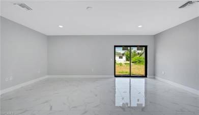 Spare room featuring baseboards, marble finish floor, and visible vents