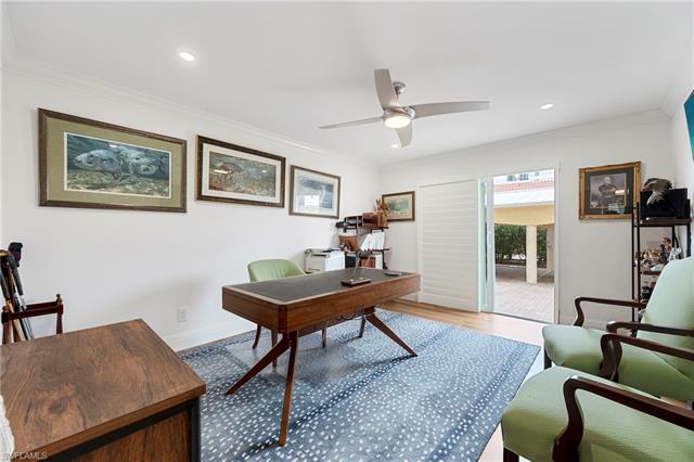 Office space with ornamental molding, wood finished floors, baseboards, ceiling fan, and recessed lighting