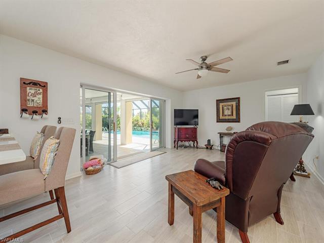 Living area with a ceiling fan and visible vents