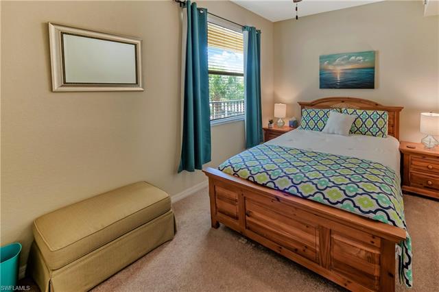Bedroom with baseboards and carpet